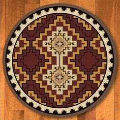 a round rug with an intricate design on the center and sides in red, brown, yellow and white colors