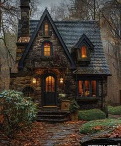 a stone house in the woods at night