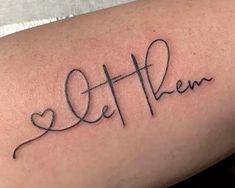 a woman's arm with the word love written in cursive writing on it