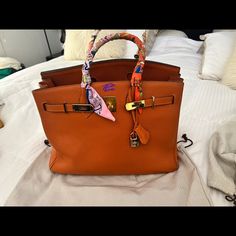 Size 35 Includes Everything Pictured Minor Wear As Shown In Pictures Needs Mild Cleaning Inside Offers Are Welcome Happy Shopping Orange Top Handle Bag With Dust Bag, Designer Orange Rectangular Bag, Designer Orange Rectangular Bags, Cognac Rectangular Bag With Branded Hardware, Designer Tan Bag With Branded Hardware, Luxury Orange Satchel For Daily Use, Designer Orange Bags For Formal Occasions, Luxury Orange Rectangular Bag, Designer Orange Formal Bags