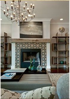 a living room filled with lots of furniture and a chandelier hanging from the ceiling