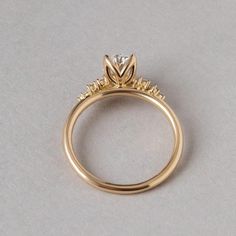 a yellow gold engagement ring with three diamonds