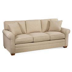 a beige couch sitting on top of a white floor