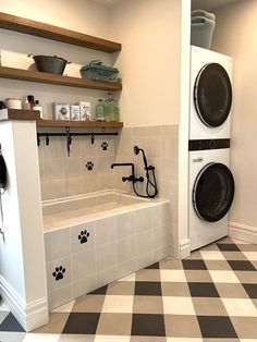 a washer and dryer in a room with black and white checkered flooring