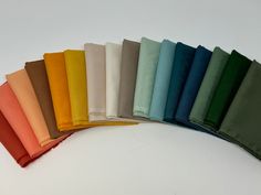 a row of different colored napkins sitting on top of each other