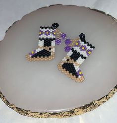 two beaded boots sitting on top of a white plate