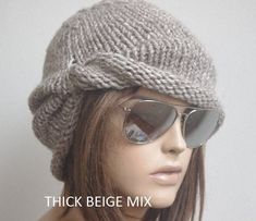 a mannequin wearing sunglasses and a knitted hat