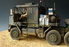 an army truck is parked on the ground with other items in it's cab