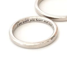 two wedding rings with the words i am with you heart and soul engraved on them