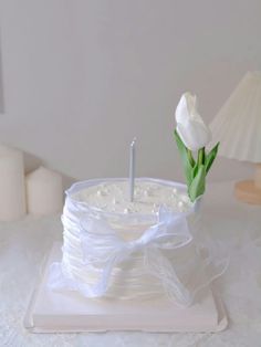 a white cake with a candle on top