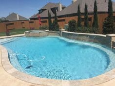 an empty swimming pool in the middle of a backyard