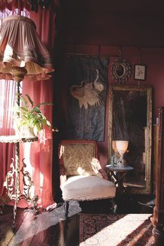 a room with a chair, mirror and lamp in it