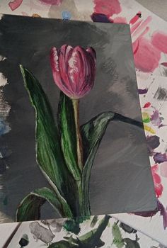 a painting of a pink tulip sitting on top of a piece of art paper