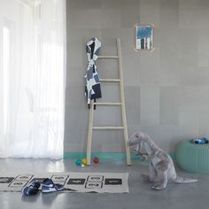 a child's room with a ladder, stuffed animal and toys on the floor