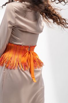 "Upgrade your style statement with this trendy handmade high and wide waist orange corset belt for women. Made with quality fabric, this belt boasts a unique fringe texture material that adds an edge to your look. The high-waist design provides excellent support and cinches your waist to enhance your curves, making it a perfect fit for any body type.  Specification: - Waist Measurements (in inches): 24 | 25 | 26 | 27 | 28 | 29 | 30 | 31 | 32 | 33 | 34 | 35 | Custom (any plus size). - Model waist Orange Color Shades, Traditional Belt, Orange Belt, Fringe Belt, Under Bust Corset, Custom Belt, Beautiful Belts, Style Steal, Corset Belt