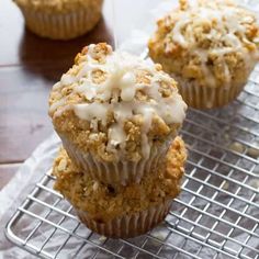 three muffins sitting on top of a cooling rack