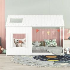 a child's bedroom with pink striped walls and white bunk beds, rugs and toys on the floor