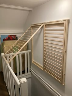 a white stair case next to a bed in a room