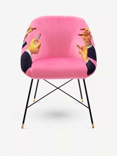 a pink chair with cartoon characters on the armrests and legs, sitting in front of a white background