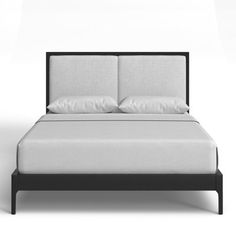 a bed with white sheets and pillows on it's headboard, in front of a wall