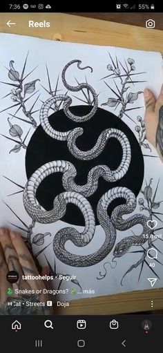 a drawing of a black and white snake on a piece of paper with sharp needles