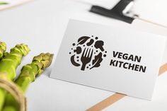 a white card with the words vegan kitchen on it next to asparagus