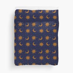 the sun and moon pattern on a blue background with stars and crescents duvet cover