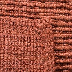 closeup of the texture of an orange rug