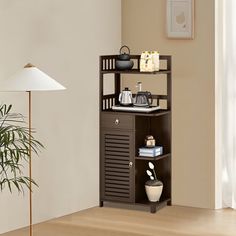 a living room with a potted plant next to a shelf