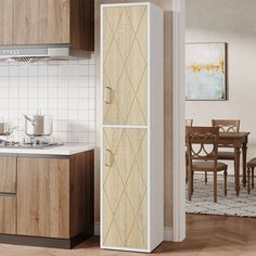 a white refrigerator freezer sitting inside of a kitchen next to a wooden table and chairs