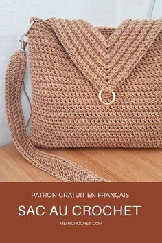 a crochet purse sitting on top of a wooden table