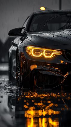 a car is shown with its lights on in the rain