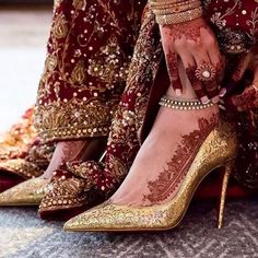 brides feet with hennap and jewelry on their ankles, both wearing high heeled shoes