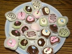 a plate full of different kinds of cupcakes