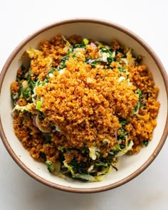 a white bowl filled with food on top of a table