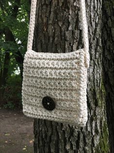 a crocheted purse hanging from a tree