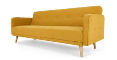 a yellow couch sitting on top of a white floor next to a wooden leg chair