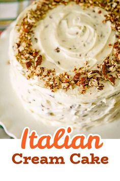 a close up of a cake on a plate with the words italian cream cake above it