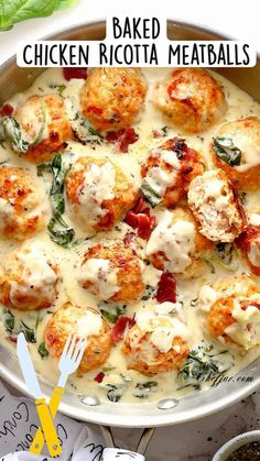 baked chicken ricotta meatballs in a skillet with spinach leaves and cheese