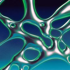 an abstract photograph of green and blue liquid swirling in the air on a dark background