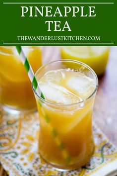 two glasses filled with pineapple tea on top of a table