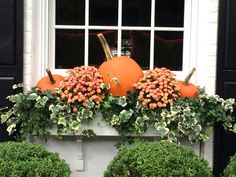 two pumpkins sitting on top of a window sill