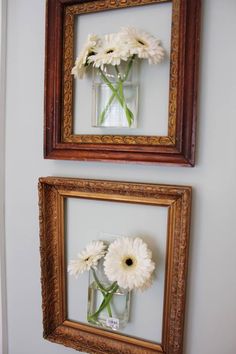 two frames with flowers in them hanging on the wall