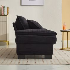 a black chair sitting on top of a tiled floor