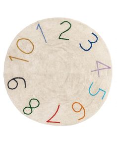 a white clock with multicolored numbers on it