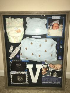 a baby's birth gift is displayed in a shadow box with photos and other items