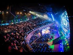 an auditorium filled with lots of people sitting down