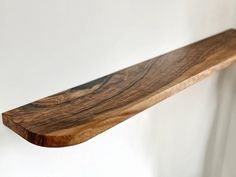 a wooden shelf hanging on the wall