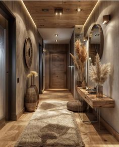 a long hallway with mirrors and vases on the wall, along with an area rug