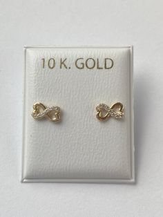 Solid yellow gold stud earrings, a gorgeous infinity design with cubic zirconia , perfectly designed for all ages but crafted with safety screw backs to protect the ears of children young girls and toddlers.  The 10K solid gold earring is perfect for babies, young girls and teenagers and beautiful enough for adults as well. Details: Metal: 10K Solid Gold Color: Yellow Gold  Size: 4x7mm Back: screw back Condition: New Note: All parts are inspected before shipping, we are not responsible if you/or Gold Infinity Earrings For Anniversary, Newborn Earrings, Earrings For Baby Girl, Toddler Presents, Gold Earrings For Kids, Ear Pin, Yellow Gold Stud Earrings, Gold Earrings Models, Infinity Earrings